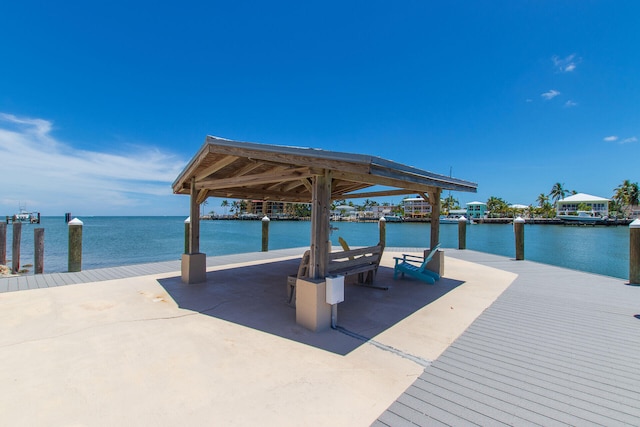 view of dock featuring a gazebo and a water view