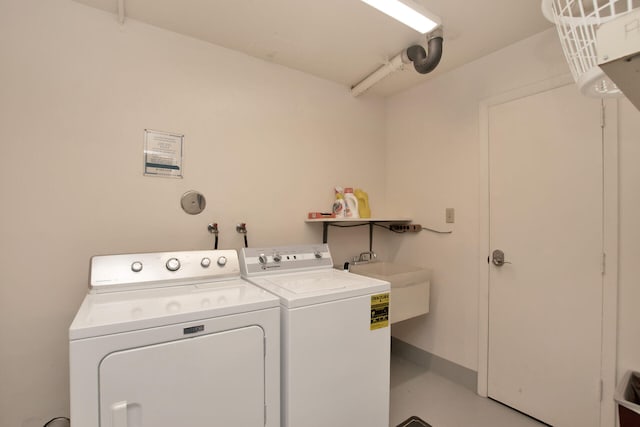 laundry room featuring a sink, laundry area, and washer and dryer