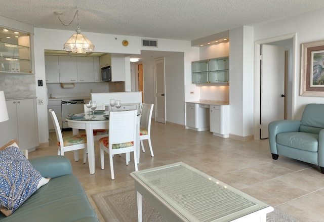 dining area with visible vents and a textured ceiling