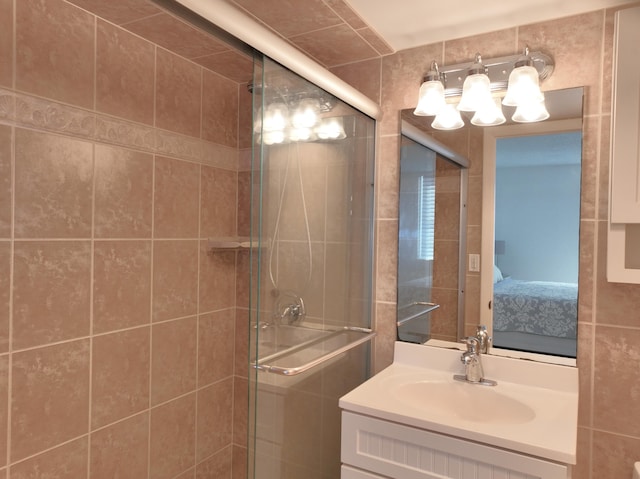 ensuite bathroom with a stall shower, vanity, and ensuite bathroom