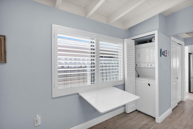 8 Sadowski Cswy, Key Colony, FL 33051 - laundry area with stacked washer and clothes dryer, baseboards, and light wood-style flooring