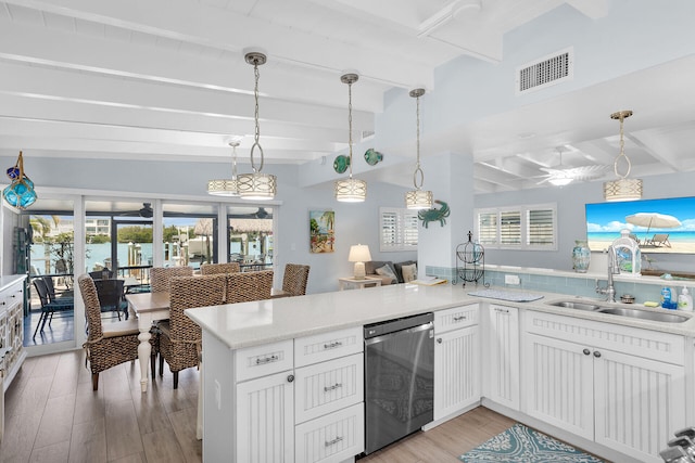 8 Sadowski Cswy, Key Colony, FL 33051 - kitchen with dishwasher, a sink, beam ceiling, light wood-type flooring, and light countertops