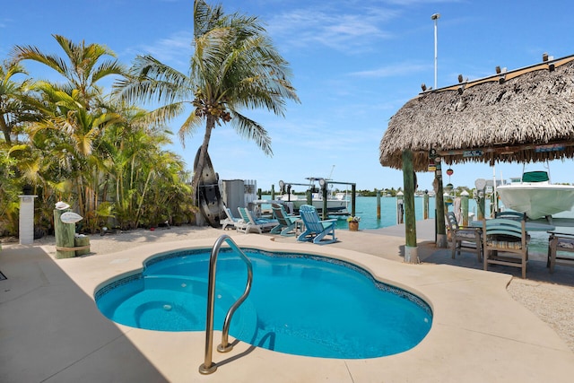 8 Sadowski Cswy, Key Colony, FL 33051 - view of swimming pool featuring boat lift, a dock, a water view, and a patio