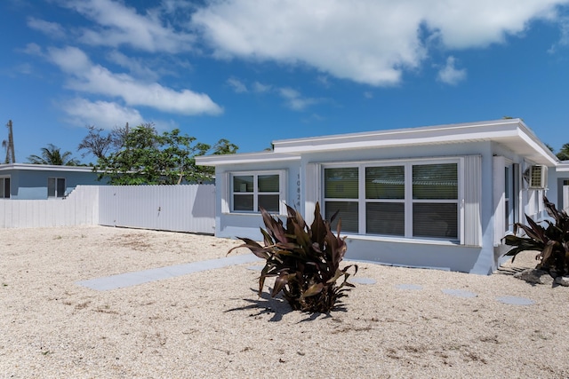 rear view of house featuring fence