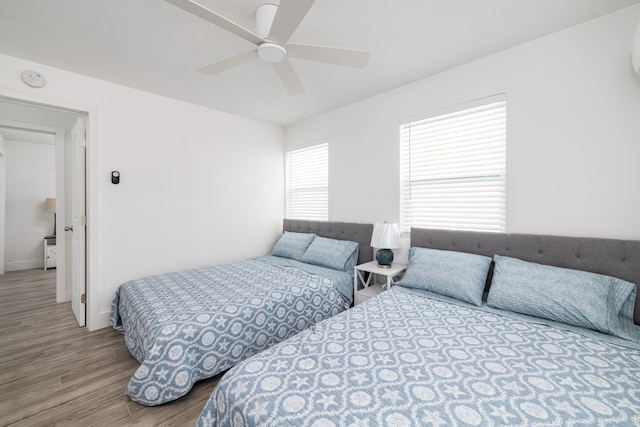 bedroom with a ceiling fan and wood finished floors