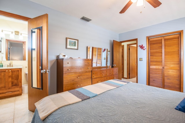 bedroom with light tile patterned floors, a closet, visible vents, a ceiling fan, and connected bathroom