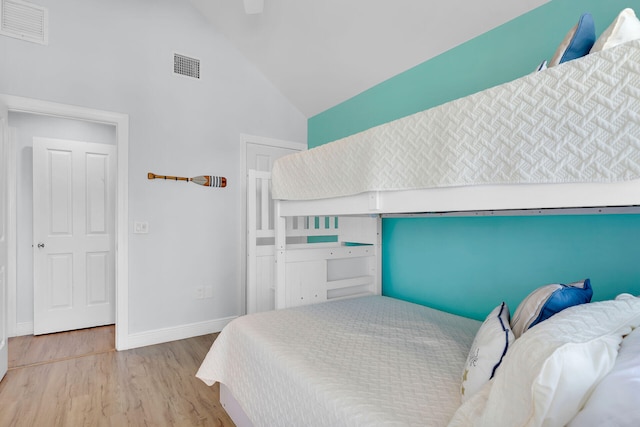 12399 Overseas Hwy Unit 12, Marathon, FL 33050 - bedroom featuring high vaulted ceiling, wood finished floors, visible vents, and baseboards