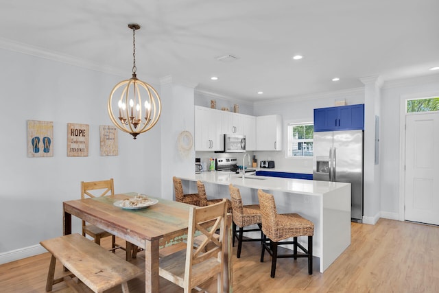 12399 Overseas Hwy Unit 12, Marathon, FL 33050 - dining room with light wood finished floors, baseboards, a chandelier, and ornamental molding