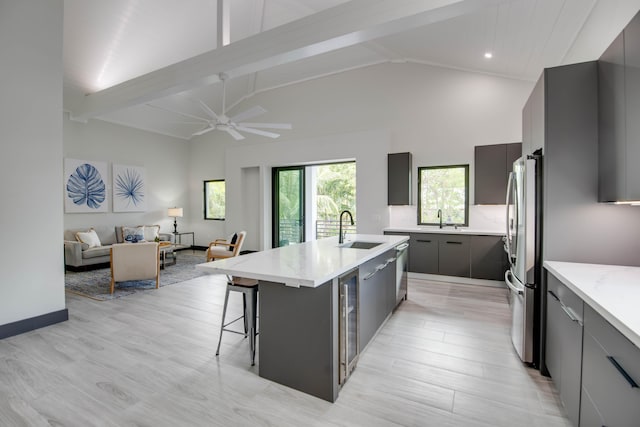 3702 Duck Ave, Key West, FL 33040 - kitchen featuring gray cabinets, light wood-style flooring, a large island with sink, a sink, and modern cabinets