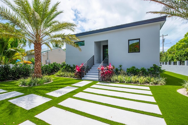 3702 Duck Ave, Key West, FL 33040 - back of property featuring a lawn, stucco siding, and fence