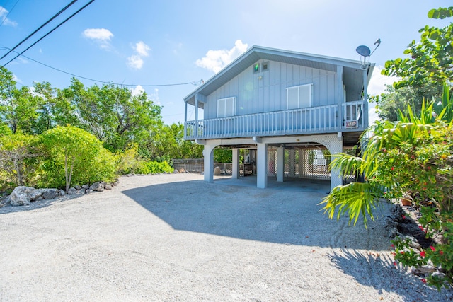 681 Indies Dr, Ramrod, FL 33042 - view of front facade featuring a carport, driveway, and board and batten siding