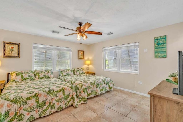 bedroom with ceiling fan, baseboards, visible vents, and light tile patterned floors