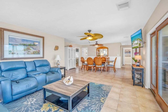 living room featuring visible vents, a ceiling fan, and light tile patterned floors