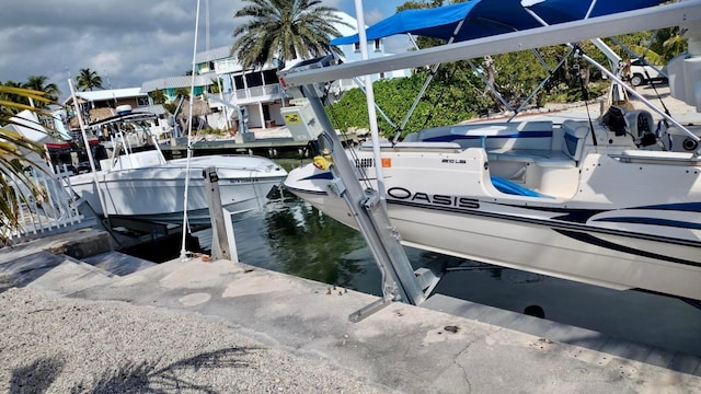 dock area with boat lift and a water view