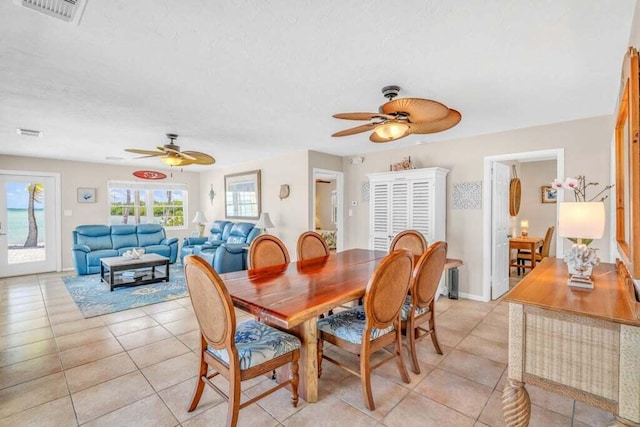 dining space featuring ceiling fan, light tile patterned flooring, and visible vents