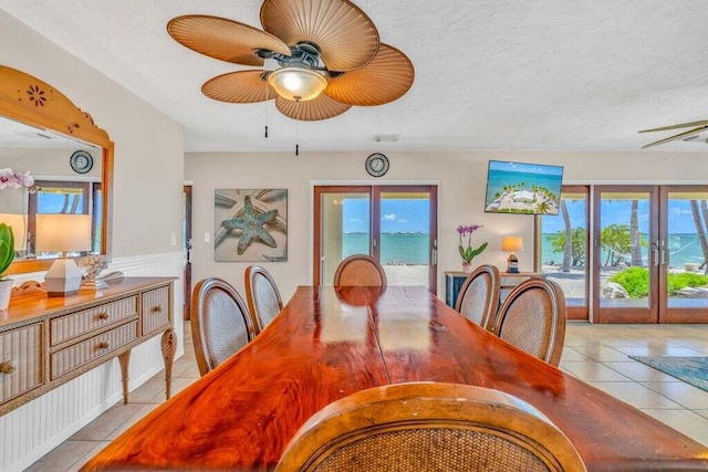 dining area with light tile patterned floors, ceiling fan, visible vents, and french doors