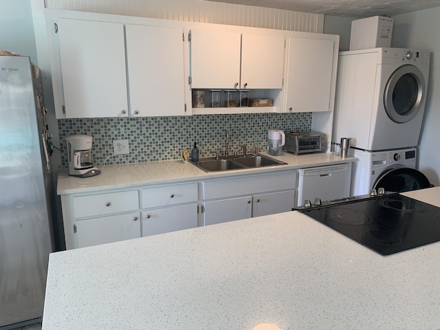 109 Stirrup Key Woods Rd Unit 1B2, Marathon, FL 33050 - kitchen featuring stacked washer / dryer, a sink, freestanding refrigerator, dishwasher, and tasteful backsplash