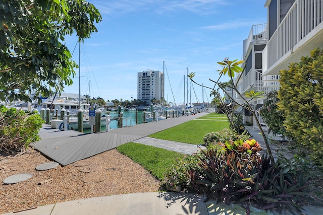 view of home's community with a dock and a water view