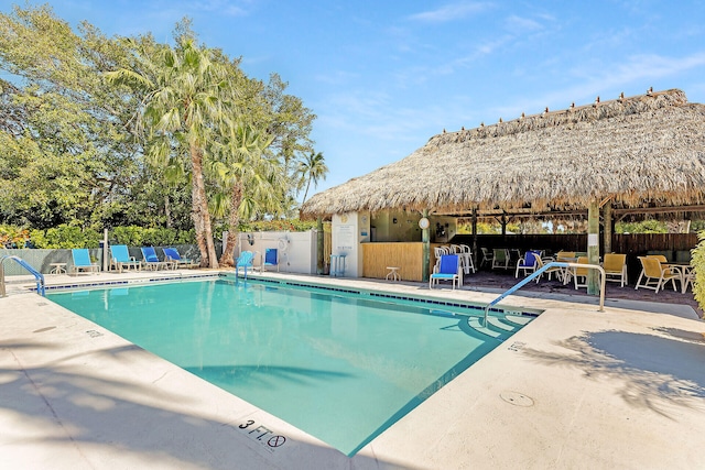 pool featuring a patio area and fence