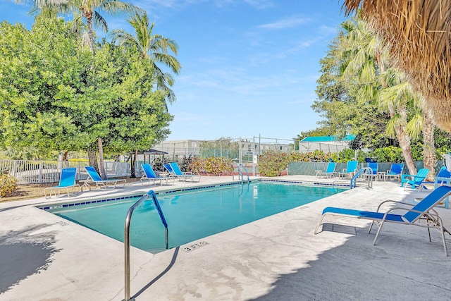 pool featuring fence and a patio