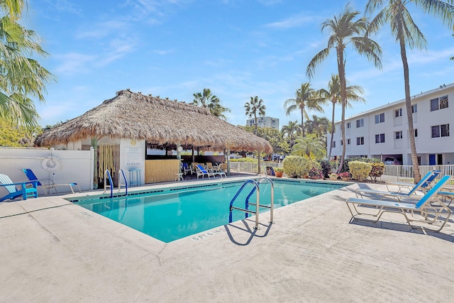 community pool featuring a gazebo, a patio area, and fence