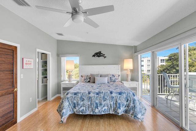 bedroom featuring access to exterior, visible vents, multiple windows, and light wood-style flooring