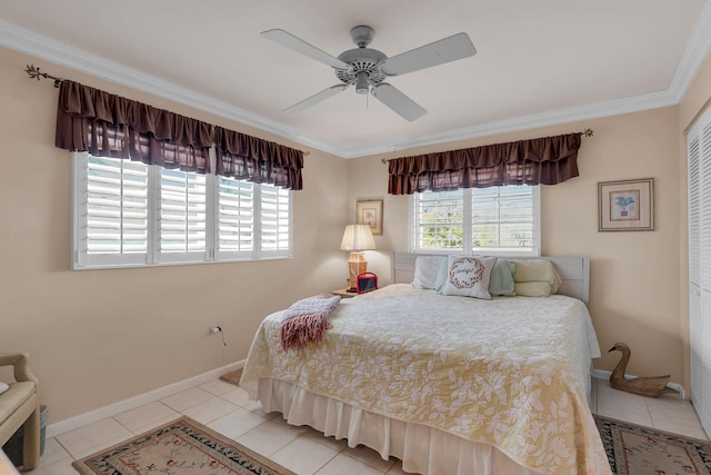 bedroom featuring baseboards, ceiling fan, ornamental molding, a closet, and light tile patterned flooring