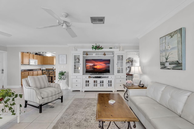 living room with light tile patterned floors, ceiling fan, visible vents, and ornamental molding