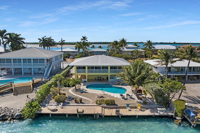 exterior space with a water view and a patio area