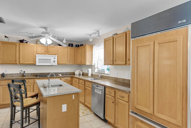 kitchen featuring white microwave, a sink, paneled built in fridge, dishwasher, and an island with sink