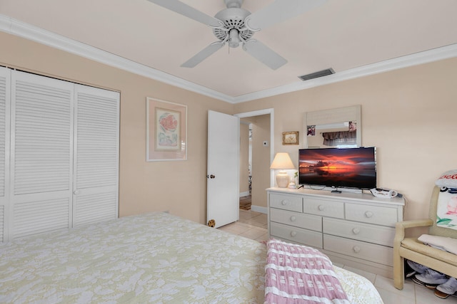 bedroom featuring ceiling fan, light tile patterned flooring, visible vents, a closet, and crown molding