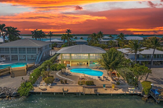 community pool featuring a patio and a dock