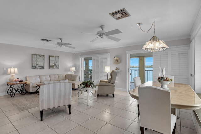 living room with light tile patterned floors, visible vents, and crown molding