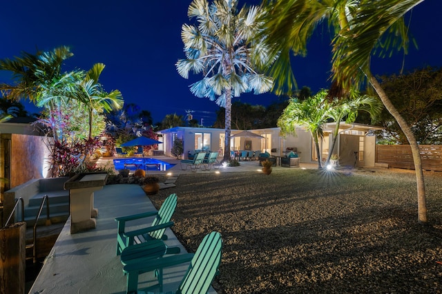280 100th St, Ocean, Marathon, FL 33050 - yard at night with a patio, fence, and a fenced in pool
