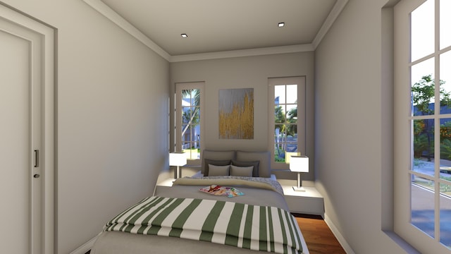 bedroom featuring baseboards, ornamental molding, and wood finished floors