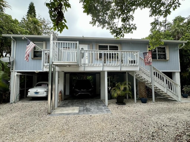 22 Stirrup Key Blvd, Marathon, FL 33050 - rear view of house with a carport, stairway, and gravel driveway