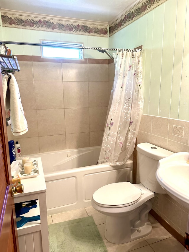 full bathroom with a sink, tile patterned flooring, shower / bath combo, toilet, and tile walls