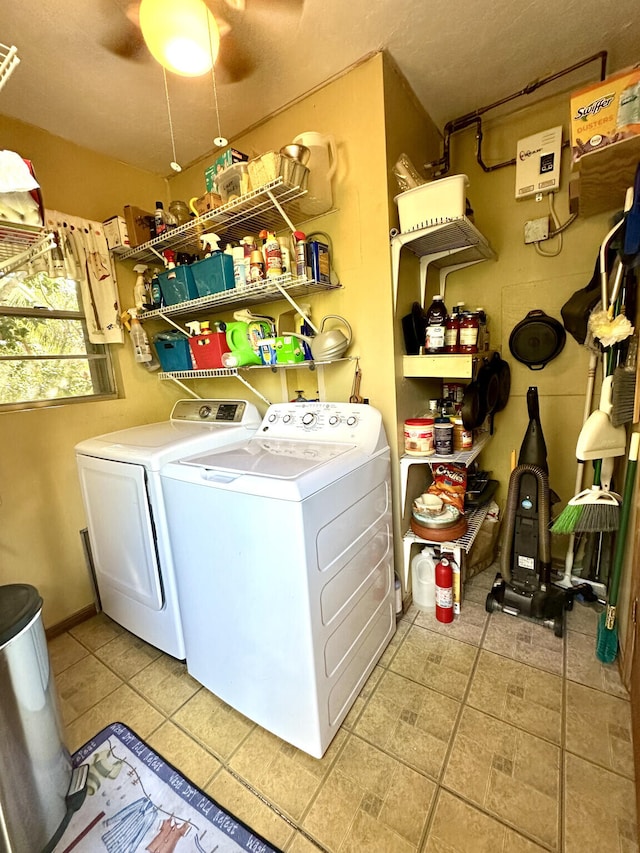 clothes washing area with light tile patterned floors, ceiling fan, laundry area, and washer and dryer