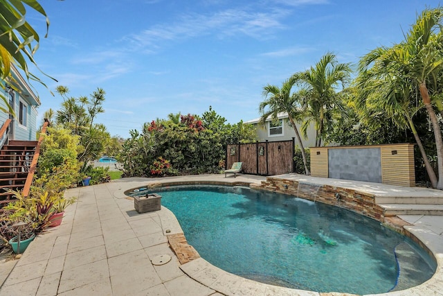 pool with fence and a patio area