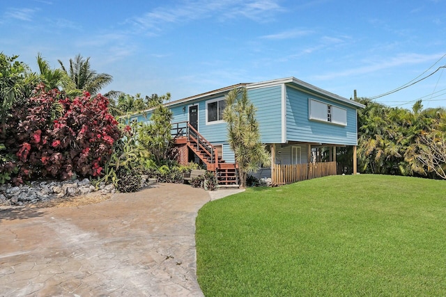 raised beach house with a front yard