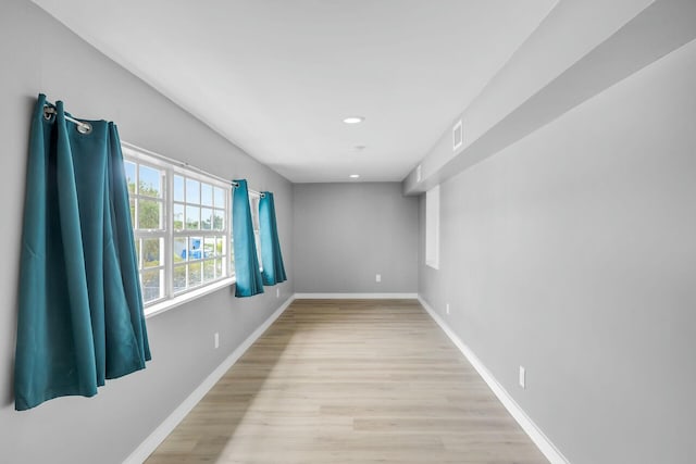 unfurnished room with recessed lighting, light wood-style flooring, and baseboards