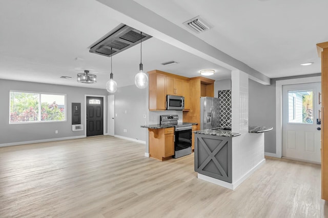 kitchen featuring light wood finished floors, visible vents, stainless steel appliances, and a wealth of natural light