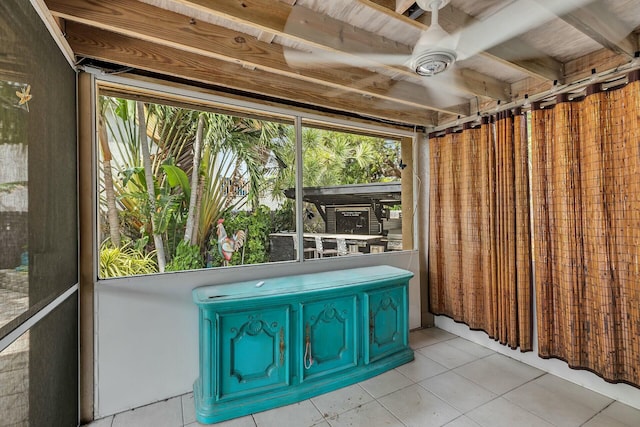 unfurnished sunroom with ceiling fan