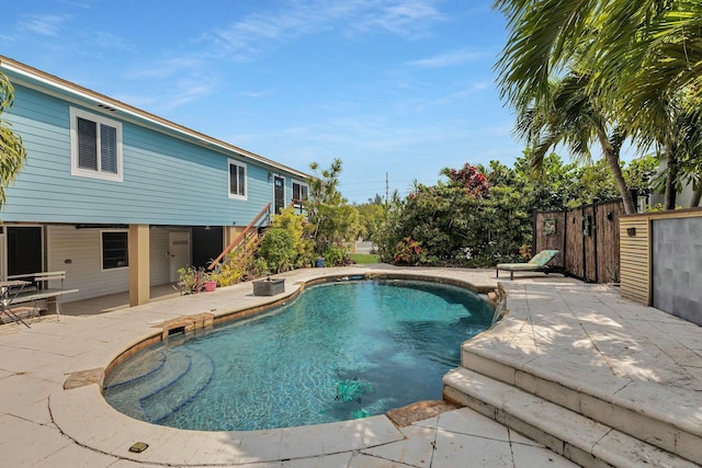 pool featuring a patio and fence