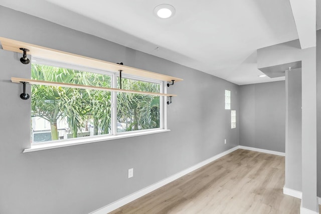 spare room with recessed lighting, wood finished floors, baseboards, and a wealth of natural light