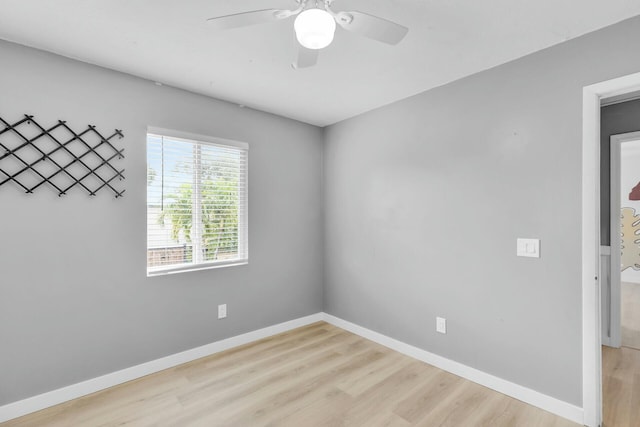 empty room with light wood finished floors, ceiling fan, and baseboards