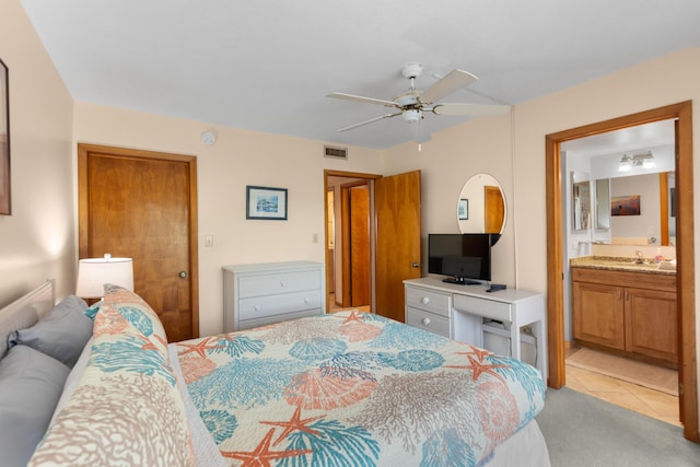 1133 Ocean Dr Unit 2, Key Colony, FL 33051 - bedroom featuring light colored carpet, light tile patterned flooring, ensuite bath, and ceiling fan