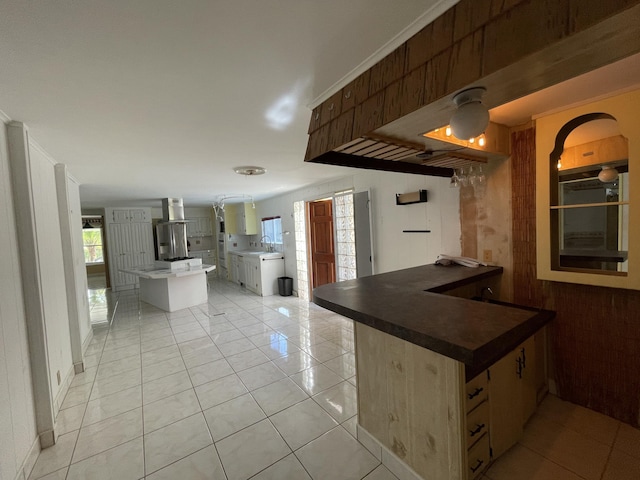 27858 Lobster Tail Trl, Little Torch, FL 33042 - kitchen featuring a sink, dark countertops, light tile patterned flooring, a peninsula, and wall chimney range hood