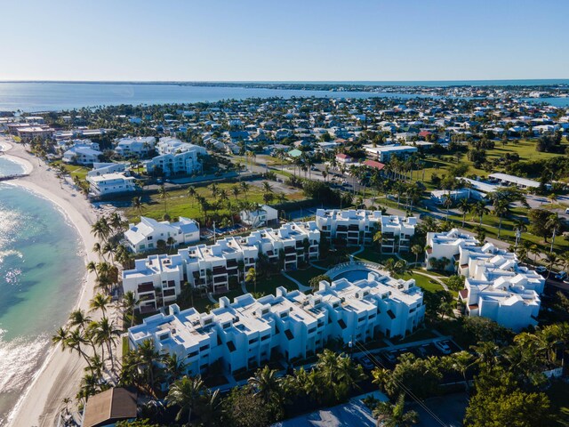 aerial view with a water view, a residential view, and a view of the beach