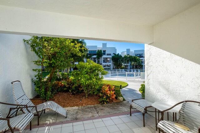 view of patio / terrace with fence and a community pool